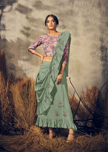 Here Is A Very Beautiful Designer Readymade Indo-Western Dress In Pink Colored Blouse Paired With Dusty Green Colores Skirt And Dupatta. This Whole Dress Is Viscose Based Beautified With Print & Hand Work. 