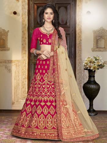 For A Proper Traditional Look, Grab This Heavy Designer Lehenga Choli In Dark Pink Color Paired With Cream Colored Blouse. Its Blouse Is Fabricated On Art Silk Paired With Satin Silk Lehenga And Net Fabricated Dupatta. It Is Beautified With Attractive Embroidery. Buy This Pretty Piece Now.