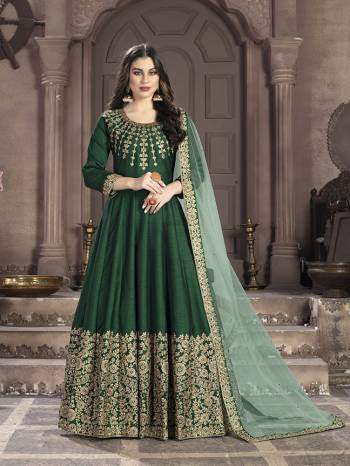 Here Is A Very Beautiful Heavy Designer Floor Length Suit In Dark Green Color Paired With Light Green Colored Dupatta. Its Top Is Fabricated On Art Silk Paired With Santoon Bottom And Net Fabricated Dupatta. It Has Heavy Embroidered Neck Line And Panel. Buy Now.