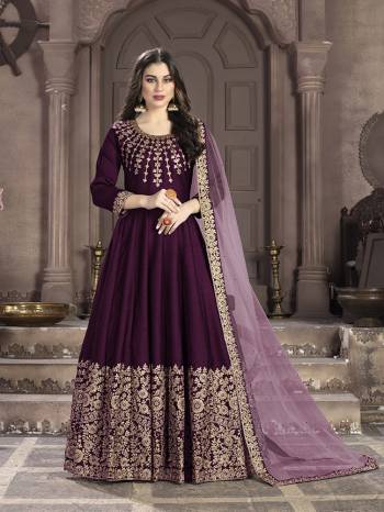 Here Is A Very Beautiful Heavy Designer Floor Length Suit In Wine Color Paired With Light Purple Colored Dupatta. Its Top Is Fabricated On Art Silk Paired With Santoon Bottom And Net Fabricated Dupatta. It Has Heavy Embroidered Neck Line And Panel. Buy Now.