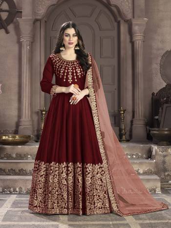 Here Is A Very Beautiful Heavy Designer Floor Length Suit In Red Color Paired With Peach Colored Dupatta. Its Top Is Fabricated On Art Silk Paired With Santoon Bottom And Net Fabricated Dupatta. It Has Heavy Embroidered Neck Line And Panel. Buy Now.