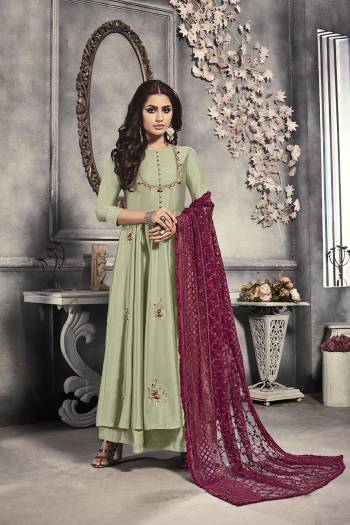 Add This Beautiful Designer Readymade Long Suit To Your Wardrobe In Pastel Green Colored Top Paired With Magenta Pink Colored Heavy Embroidered Dupatta. This Top Is Fabricated On Satin Paired With Net Fabricated Dupatta. 