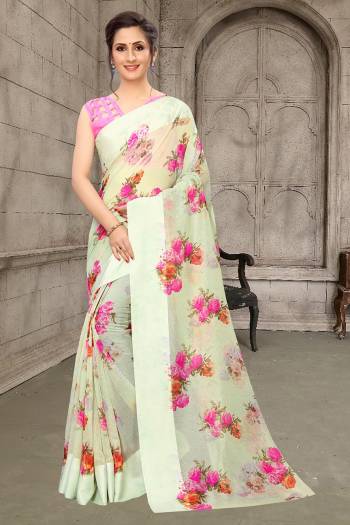 Here Is A Very Pretty And Elegant Looking Designer Saree In Pastel Green Color Paired With Pink Colored Blouse. This Saree And Blouse Are Linen Cotton Based Beautified With Pretty Floral Prints. It Is Light Weight, Durable And Easy To Carry All Day Long. 