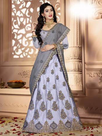 Flaunt Your Rich And Elegant Taste Wearing This Designer Lehenga Choli In All Over Grey Color. Its Blouse Is Fabricated On Art Silk Paired With Satin Silk Fabricated Lehenga And Net Fabricated Dupatta. It Is Beautified With Pretty Tone To Tone Embroidery. 