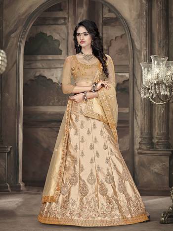 Flaunt Your Rich And Elegant Taste Wearing This Designer Lehenga Choli In All Over Beige Color. Its Blouse Is Fabricated On Art Silk Paired With Satin Silk Fabricated Lehenga And Net Fabricated Dupatta. It Is Beautified With Pretty Tone To Tone Embroidery. 