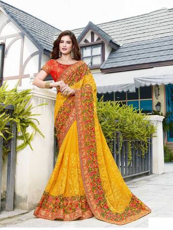 Celebrate This Festive And Wedding Season Wearing This Beautiful Heavy Designer Saree In Yellow Color Paired With Orange Colored Blouse. This Saree Is Fabricated On Georgette Paired With Art Silk Fabricated Blouse. Buy Now. 