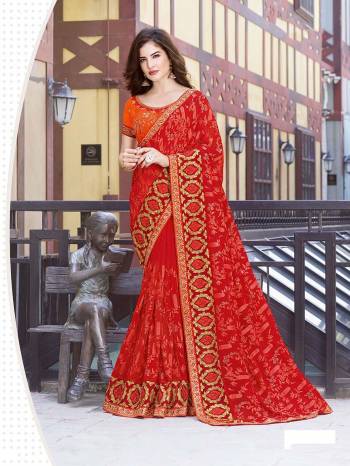 Catch All The Limelight At The Next Function You Attend Wearing This Lovely Designer Saree In Red Color Paired With Orange Colored Blouse. This Pretty Embroidered Saree Is Fabricated On Georgette Paired With Art Silk Fabricated Blouse. 