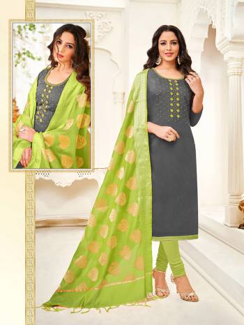 Here Is A Royal Looking Designer Straight Suit In Grey Colored Top Paired With Contrasting Green Colored Bottom And Dupatta. Its Top Is Fabricated On Cotton Silk Paired With Cotton Bottom And Jacquard Silk Fabricated Dupatta. It Is Beautified With Hand Work. 