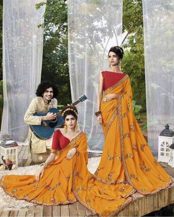 Add This Beautiful Heavy Designer Saree To Your Wardrobe In Musturd Yellow Color Paired With Red Colored Blouse. This Saree And Blouse Are Fabricated On Art Silk Beautified With Heavy Embroidery. 