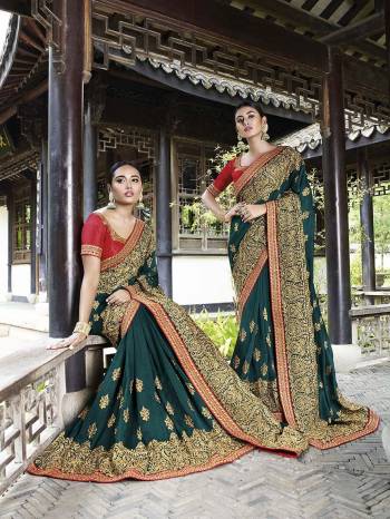 Celebrate This Festive And Wedding Season Wearing This Heavy Designer Saree In Teal Green Color Paired With Red Colored Blouse. This Pretty Saree And Blouse Are Silk Based Beautified With Heavy Embroidery Work. 