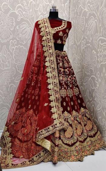 Here Is A Royal Looking Heavy Bridal Lehenga Choli In Maroon Color. Its Blouse And Lehenga Are Fabricated On Velvet Paired With Net Fabricated Dupatta. This Designer Heavy Bridal Lehenga Choli Has Attractive Peacock Motifs. Buy Now.