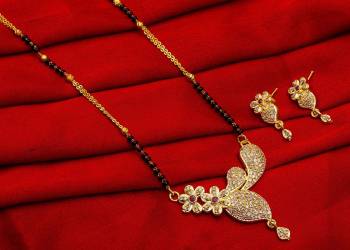 Grab This Designer Heavy Mangalsutra In Golden And Black Color Beautified With Diamond Work. This Mangalsutra Comes With A Set Of Pretty Matching Earrings. It Is Light In Weight And Easy To Carry Throughout The Gala. Buy Now.