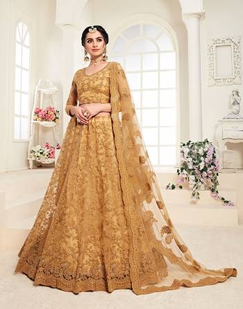 Get Ready For The Upcoming Wedding Season Wearing This Lovely Tone To Tone Heavy Embroidered Lehenga Choli In Occur Yellow Color. Its Blouse, Lehenga And Dupatta Are Fabricated On Net Which Comes With Same Colored Satin Silk Inner. Pair This Up With Delicate Pearl Accessories for A Look Like Never Before. 