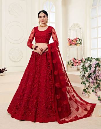 Catch All The Limelight At The Next Wedding You Attend Wearing This Very Attractive And Heavy Designer Lehenga Choli In All Over Red Color. This Lehenga Choli Is Net Based Paired With Net Fabricated Dupatta. It Is Beautified With Tone to Tone Embroidery Higihted With Stone Work. 