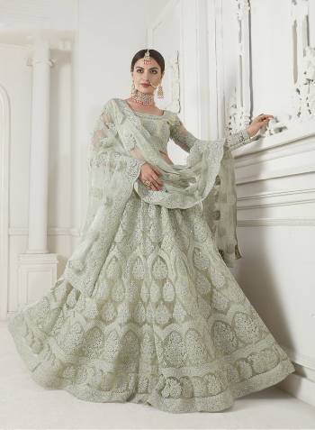 Look Ravishing Wearing This Heavy Deisgner Lehenga Choli In All Over Pastel Pink Color. Its Detailed Embroidered Blouse, Lehenga And Dupatta Are Fabricated Net Beautified With Elegant Tone To Tone Resham And Coding Work Highlited With Stones. Buy This Heavy Yet Subtle Look Designer Lehenga Choli Now.