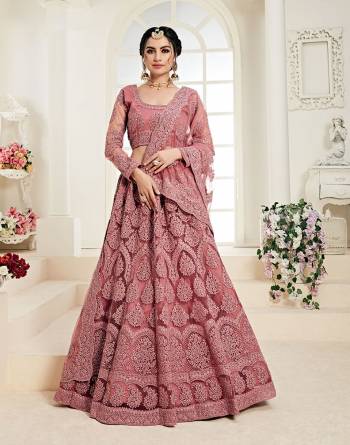 Flaunt Your Rich And Elegant Taste Wearing This Very Pretty Heavy Designer Lehenga Choli In All Over Dusty Pink Color. This Pretty Lehenga Choli Is Fabricated On Net Paired With Net Fabricated Dupatta. It Is Beautified With Heavy Tone To Tone Embroidery Giving It A Pretty Subtle Yet Heavy Look.