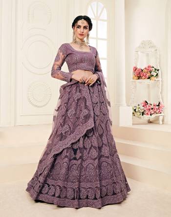 Get Ready For The Upcoming Wedding Season Wearing This Lovely Tone To Tone Heavy Embroidered Lehenga Choli In Dusty Purple Color. Its Blouse, Lehenga And Dupatta Are Fabricated On Net Which Comes With Same Colored Satin Silk Inner. Pair This Up With Delicate Pearl Accessories for A Look Like Never Before. 