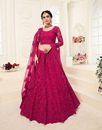 Get Ready For The Upcoming Wedding Season Wearing This Lovely Tone To Tone Heavy Embroidered Lehenga Choli In Rani Pink Color. Its Blouse, Lehenga And Dupatta Are Fabricated On Net Which Comes With Same Colored Satin Silk Inner. Pair This Up With Delicate Pearl Accessories for A Look Like Never Before. 