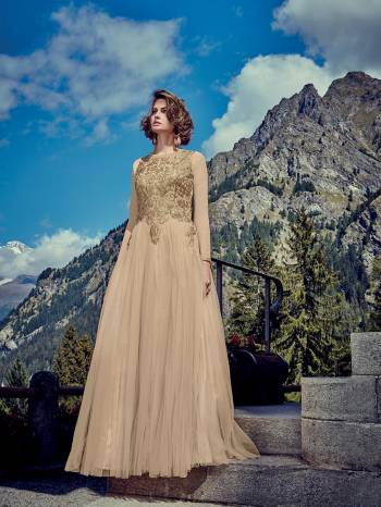 Flaunt Your Rich And Elegant Taste Wearing This Designer Readymade Gown In All Over Beige Color. This Pretty Attractive Gown Is Fabricated Net Beautified With Stone Work Paired With Chiffon Fabricated Dupatta. Buy Now.