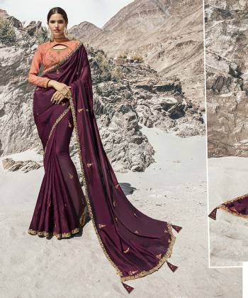 Here Is A Beautiful Designer Saree To Add Into Ypur Wardrobe For The Upcoming Wedding And Festive Season In Wine Color Paired With Contrasting Dark Peach Colored Blouse. This Saree And Blouse Are Silk Based Which Gives A Rich Look To Your Personality. 