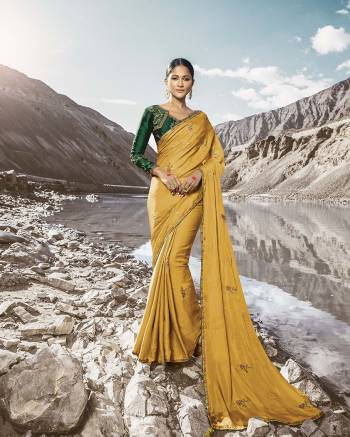 This Festive And Wedding Season Lok The Most Gorgeous Of All In This Designer Musturd Yellow Colored Saree Paired With Contrasting Dark Green Colored Blouse. This Saree And Blouse Are Silk Based Beautified With Detailed Attractive Embroidery. Buy Now.