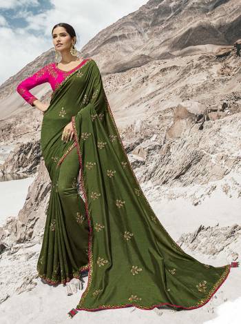 This Festive And Wedding Season Lok The Most Gorgeous Of All In This Designer Olive Green Colored Saree Paired With Contrasting Rani Pink Colored Blouse. This Saree And Blouse Are Silk Based Beautified With Detailed Attractive Embroidery. Buy Now.