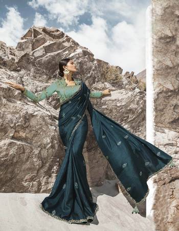 Attract All Wearing This Desiger Saree In Teal Blue Color Paired With Contrasting Turquoise Blue Colored Heavy Embroidered Blouse. This Saree Is Fabricated on Soft Silk Paired With Art Silk Fabricated Blouse. 