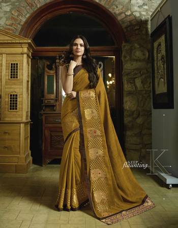 Enhance Your Personality Wearing This Designer Saree In Musturd Yellow Color Paired With Brown Colored Blouse. This Saree Is Fabricated on Slub Silk Paired With Art Silk Fabricated Blouse. It Is Beautified With Jari & Resham Work Giving An Attractive Look. 
