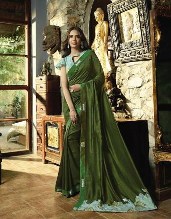 Celebrate This Festive Season Wearing This Pretty Designer Saree In Green Color Paired With Contrasting Sky Blue Colored Blouse. This Saree And Blouse Are Silk Based Which Gives A Rich Look To Your Personality. 