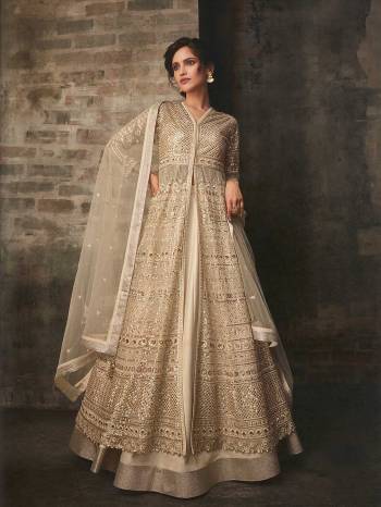 Flaunt Your Rich And Elegant Taste Wearing This Designer Indo-Western Suit In All Over Cream Color. Its Lovely Heavy Embroidered Top Is Fabricated On Net Paired With Art Silk Lehenga With A Satin Fabricated Bottom And Net Fabricated Dupatta. You Can Get Two Looks In One Dress As It Is Available With Two Bottoms. Buy Now.