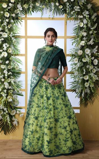 Here Is A Very Pretty Designer Lehenga Choli In Pine Green Colored Blouse Paired With Light Green Colored Lehenga And Dupatta. Its Blouse Is Fabricated On Art Silk Paired With Net Fabricated Lehenga And Dupatta. It Is Beautified With Pretty Thread Embroidery and Stone work