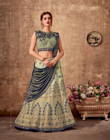 Embrace the very beauty of harmony in this pastel green and blue saree-lehenga ornamneted with stunning weaves and embroideries. Pair with subtle and simple jewels to make the most of this look. 