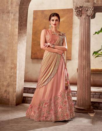 Exuding old-world charm and glamour in this Peach lehenga saree with just the right amount of sheen and shine fancied with tonal embroidery and appliqued flowers. 