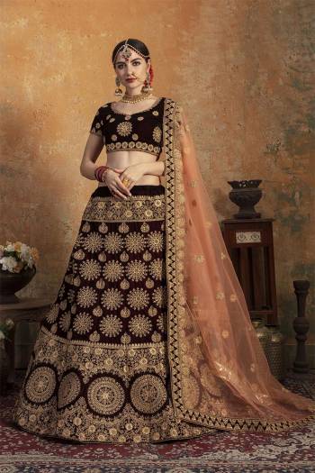 Here Is A Perfect Bridal Look For You In The Running Treand With This Heavy designer Lehenga Choli In Dark Maroon Color Paired With Contrasting Peach Colored Dupatta. This Lehenga Choli Is Velvet Based Paired With Net Fabricated Dupatta.Its Fabric Also Ensures Superb Comfort Throughout The Gala.