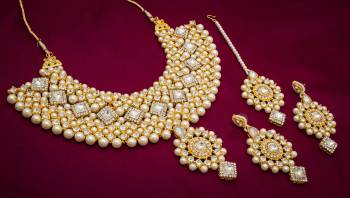 This Wedding Season Give Your Attire More Heavy And Elegant Look?Pairing It With This Attractive Heavy Necklace Set In Golden Comes With A Pair Of Earrings And A Maang Tika. This Can Be Paired With Any Colored Traditional Attire. Buy Now.?