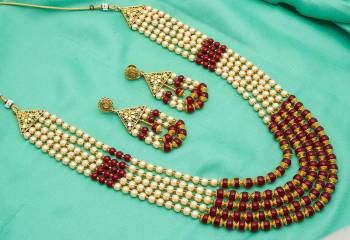 Give An Enhanced Look To Your Personality By Pairing Up This Beautiful Necklace Set With Your Ethnic Attire. This Pretty Set Is In Golden Color Beautified With Stone And Pearl Work. Buy Now