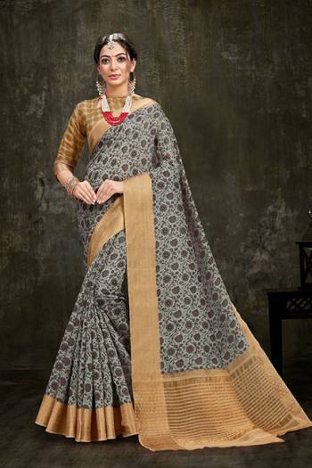 Celebrate This Festive Season Wearing This Pretty Saree In Grey Color Paired With Beige Colored Blouse. This Saree And Blouse Are Fabricated On Cotton Silk Beautified With Prints All Over And Also Jacquard Silk  Border. 