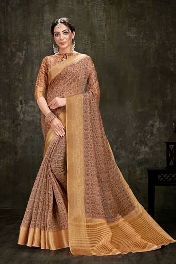 Add This Pretty Printed Saree To Your Wardrobe In Light Brown Color Paired With Light Brown Colored Blouse. This Saree And Blouse Are Fabricated On Cotton Silk Beautified With Prints And Jacquard Lace Border. 