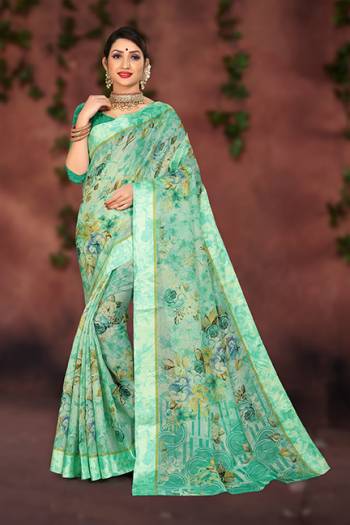 Look Pretty In This Sea Green Colored Saree Paired With Sea Green Colored Blouse. This Saree And Blouse Are Fabricated On Cotton Silk Beautified With Prints And Satin Border. 