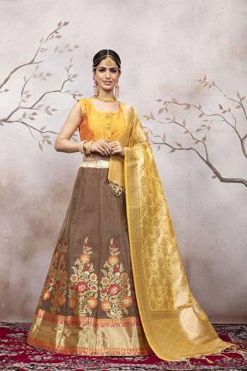 Celebrate This Festive And Wedding Season Wearing This Pretty Designer Lehenga Choli In Musturd Yellow Colored Blouse And Dupatta Paired With Light Brown Colored Lehenga. This Silk Based Lehenga Choli Will Give A Rich Look To Your Personality. 