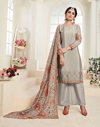 Flaunt Your Rich And Elegant Taste Wearing This Designer Straight Suit In Grey Color. Its Heavy Embroidered Top and Dupatta Are Fabricated On Chinon Paired With Santoon Bottom. It Has Pretty Attractive Resham & Jari Embroidery With Stone Work. 