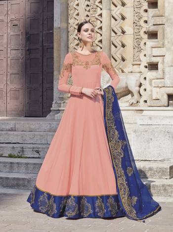 Look Pretty In This Lovely Suit For The Upcoming Wedding And Festive Season In Light Peach Color Paired With Contrasting Royal Blue Colored Dupatta. Its Top Is Fabricated On Georgette Paired With Satin Bottom And Net Fabricated Dupatta. Its Top And Dupatta Are Beautified With Heavy Embroidery Giving An Attractive Look. 