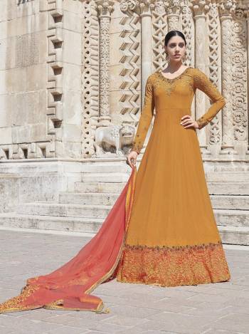 Celebrate This Festive Season Wearing This Heavy Designer Floor Length Suit In Musturd Yellow Color Paired With Dark Peach Colored Dupatta. Its Top Is Georgette Based Paired With satin Bottom And Net Fabricated Dupatta. Buy This Lovely Semi-Stitched Suit Now.