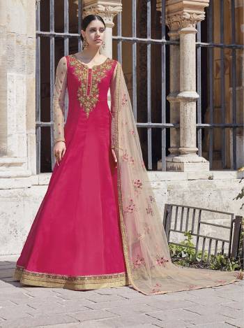 Shine Bright Wearing This Lovely Rani Pink Colored Heavy Designer Floor Length Suit Paired With Off-White Colored Dupatta. Its Top Is Fabricated On Georgette Paired With Satin Bottom And Net Fabricated Dupatta. 