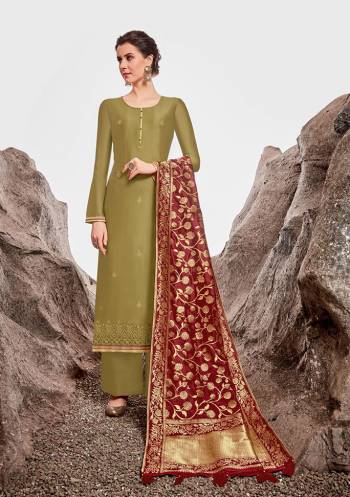 Add This Lovely Designer Straight Suit To Your Wardrobe In Olive Green Color Paired With Contrasting Maroon Colored Dupatta. Its Pretty Top Is Fabricated On Nylon Chanderi Paired With Cotton Satin Bottom And Jacquard Silk Fabricated Dupatta. Its Top Is Beautified With Attractive Stone Work and Weaved Dupatta. 