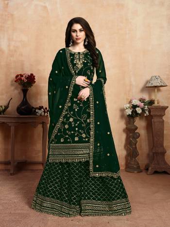 Add This Very Beautiful Heavy Designer Sharara Suit To your Wardrobe In Dark Green Color. This Heavy Embroidered Suit Is Fabricated On Georgette. It Is Light In Weight And Easy To Carry All Day Long. 