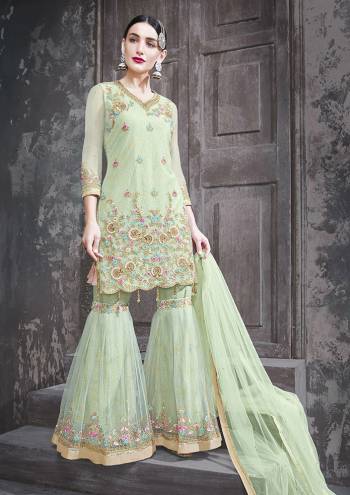 This Season Is About Subtle Shades And Pastel Play, So Grab This Beautiful Heavy Deisgner Sharara Suit In Pastel Green Color. Its Embroidered Top and Dupatta are Fabricated On Net Paired With Net Fabricated Dupatta Beautified with Lace Border And Stone Work.