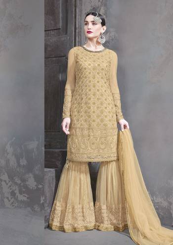 Flaunt Your Rich and Elegant Taste Wearing This Designer Sharara Suit In Elegant Beige Color. This Pretty Semi-Stitched Suit In Fabricated on Net Beautified Subtle Embroidery Giving Heavy Look. 