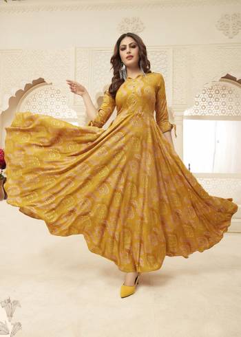 Celebrate This Festive Season With Beauty And Comfort Wearing This Designer Readymade Gown In Musturd Yellow Color Fabricated On Rayon. It Is Beautified With Prints. Buy Now.