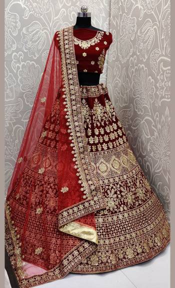 Get Ready For Your D-Day With This Heavy Designer Lehenga Choli In Maroon Color. This Heavy Embroidered Lehenga Choli Is Fabricated On Velvet Paired With Net Fabricated Dupatta. It Is Beautified With Heavy Jari Embroidery And Stone Work. Buy This Bridal Lehenga Now